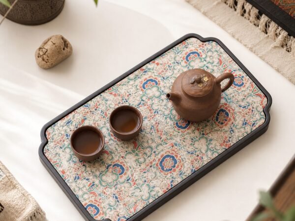 Brocade Bamboo Tea Tray with teapot and teacups on a floral patterned surface