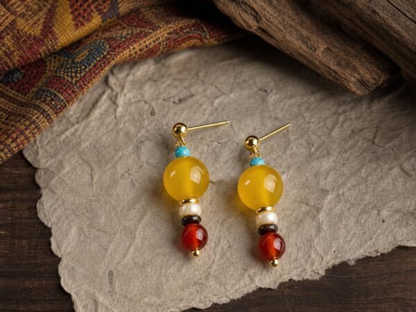 Post Earrings with amber-toned yellow jade, tiger’s-eye detail, red agate, shell, turquoise-colored bead and gold-tone copper
