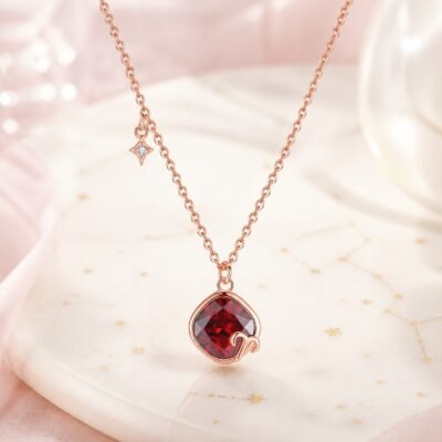 Aries rose gold crystal zodiac necklace with garnet-red crystal and Aries glyph