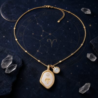 Zodiac birthstone necklace with pearlescent Aries medallion and clear quartz charm