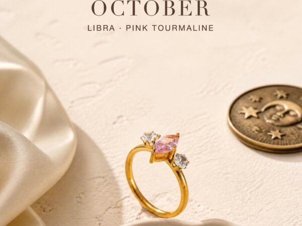 Pink tourmaline ring with a gold-tone marquise trio setting and two clear accent crystals