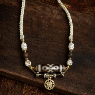 Dzi Charm Necklace with adjustable cord, tassel, and symbolic focal bead