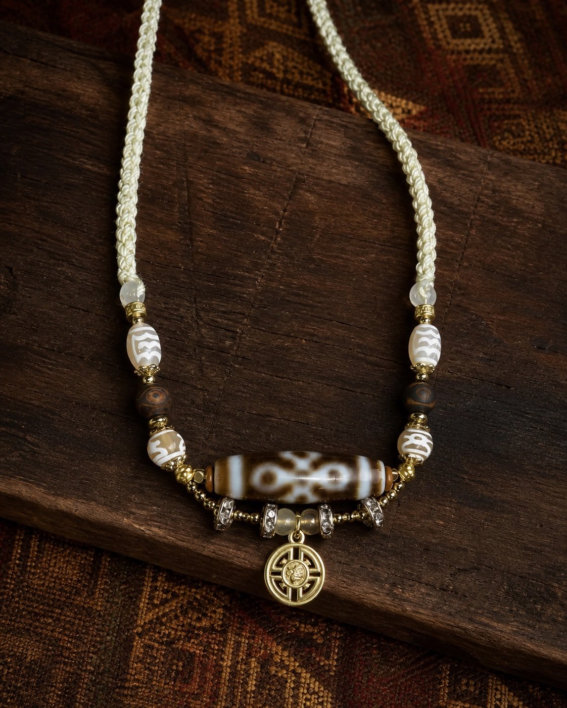 Dzi Charm Necklace with adjustable cord, tassel, and symbolic focal bead