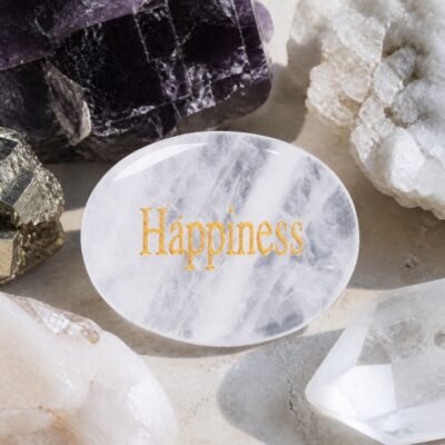 Clear quartz palm stone engraved with Happiness