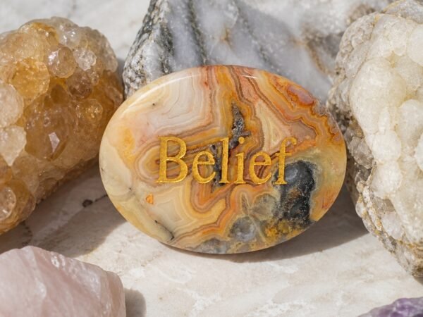 Crazy lace agate palm stone engraved with Belief