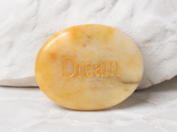 Yellow jade palm stone engraved with Dream