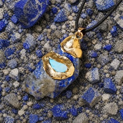 Lapis lazuli raw crystal pendant with gold-tone wrap and black hand-braided cord