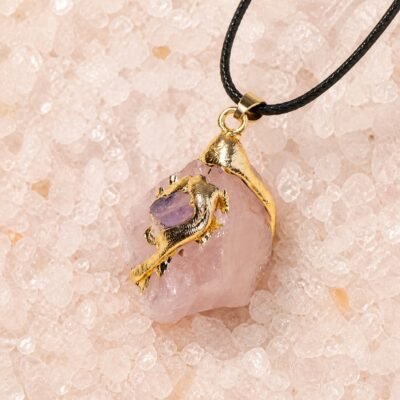 Rose quartz raw crystal pendant with gold-tone wrap and black hand-braided cord