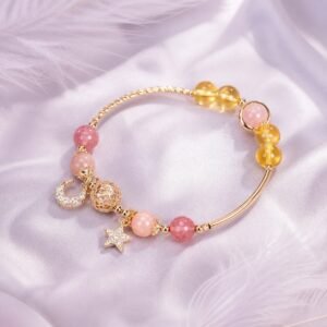 Citrine star bracelet with hollow-orb detail and star-and-moon charms.