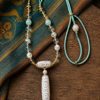 Ivory Eight-Eye Dzi Necklace with white 38 mm focal bead, aqua accents, and sage-green cord