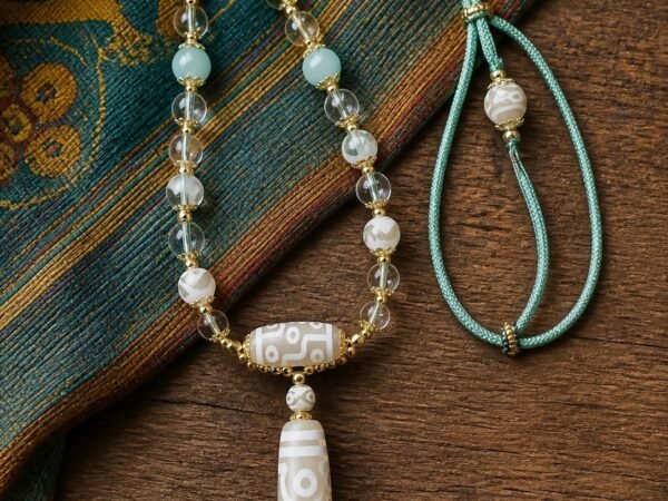 Ivory Eight-Eye Dzi Necklace with white 38 mm focal bead, aqua accents, and sage-green cord