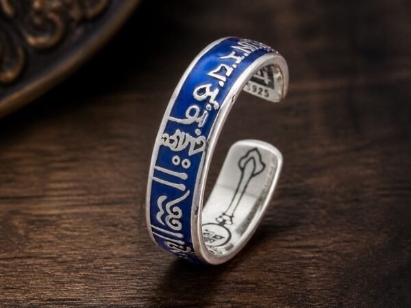 Wisdom Mantra Ring with raised mantra-style copper details and a blue resin-dome finish
