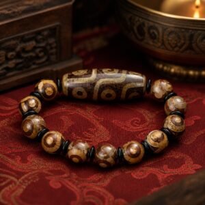 Tibetan Dzi bracelet with nine-eye chalcedony Dzi-style focal bead, earth-toned patterning and elastic cord