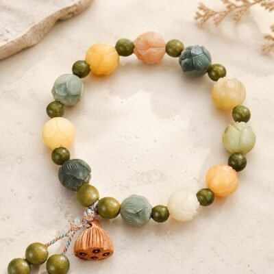 Prosperity Lotus Bracelet with green sandalwood-style beads and a carved lotus-pod charm