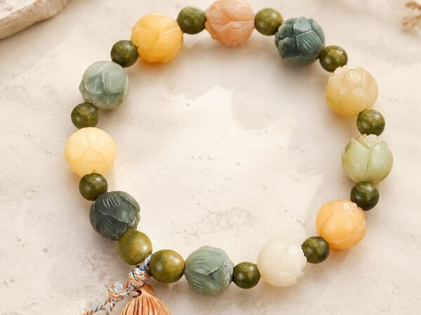 Prosperity Lotus Bracelet with green sandalwood-style beads and a carved lotus-pod charm