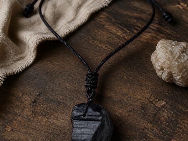 Black obsidian raw crystal pendant on adjustable black braided cord