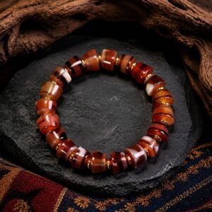 Red Agate Dzi Bracelet with banded red-brown agate beads arranged in a circle on a dark background.