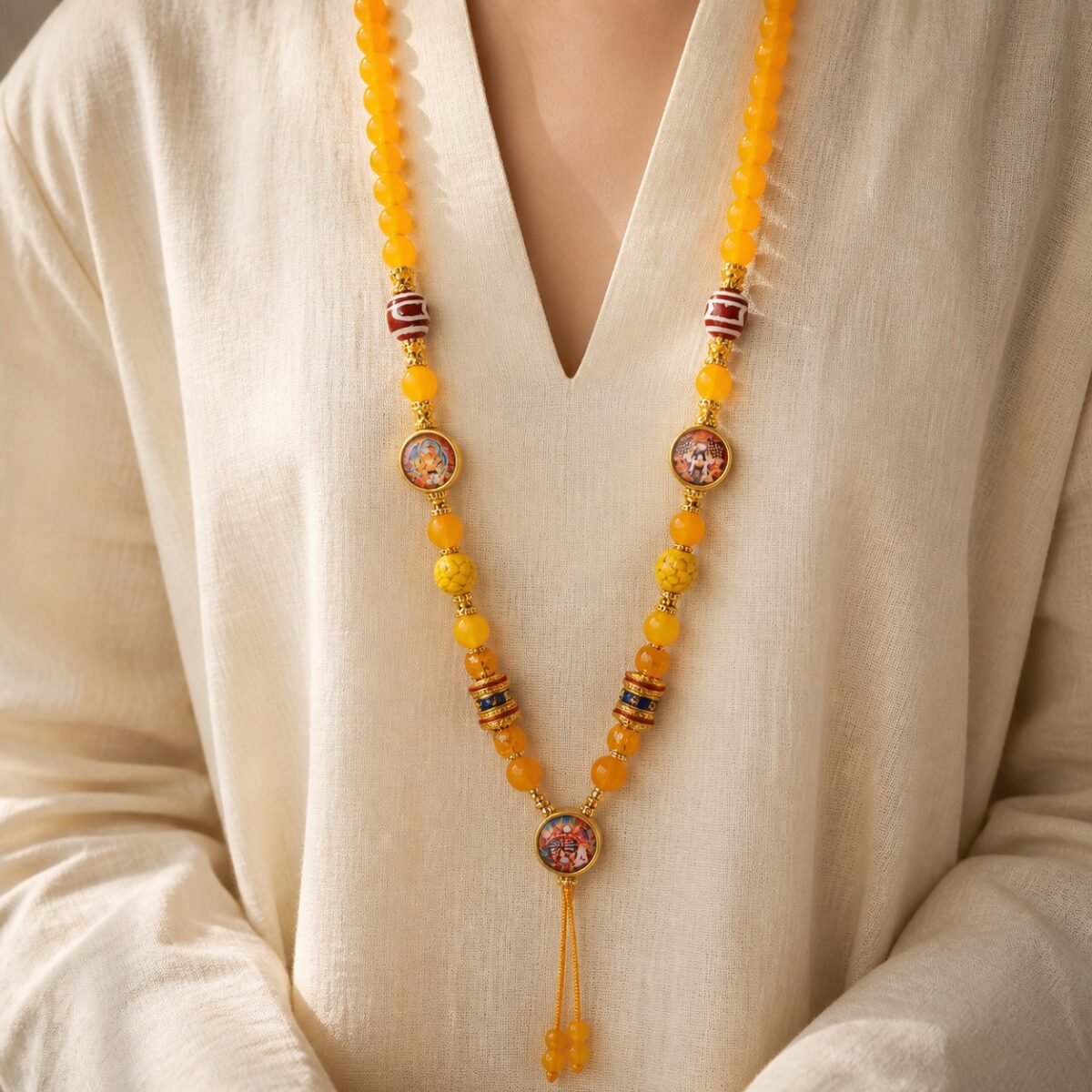 yellow-agate-thangka-wealth-pendant-chain-02-wearing-front Yellow Agate Thangka Pendant Chain worn, showing striped prayer beads and tassel