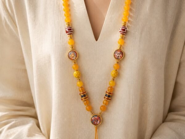 Yellow Agate Thangka Pendant Chain worn, showing striped prayer beads and tassel