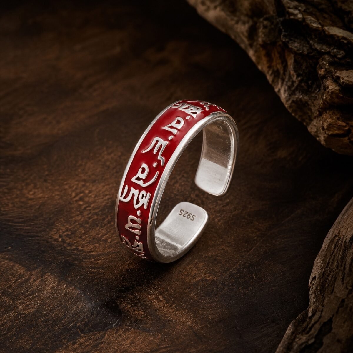Wealth mantra ring with raised details and red resin-dome finish