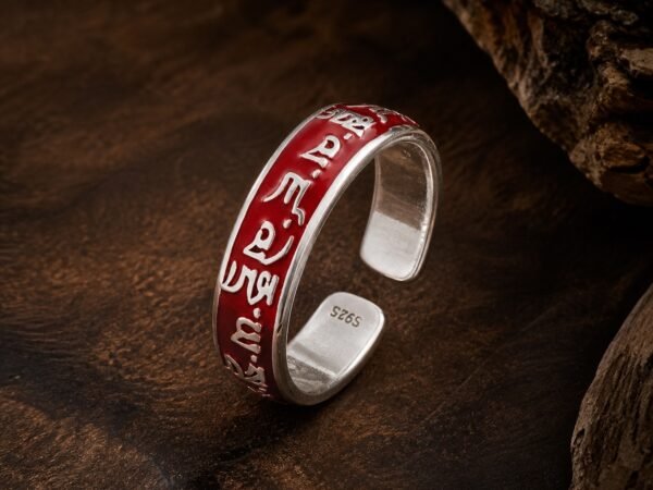 Wealth mantra ring with raised details and red resin-dome finish