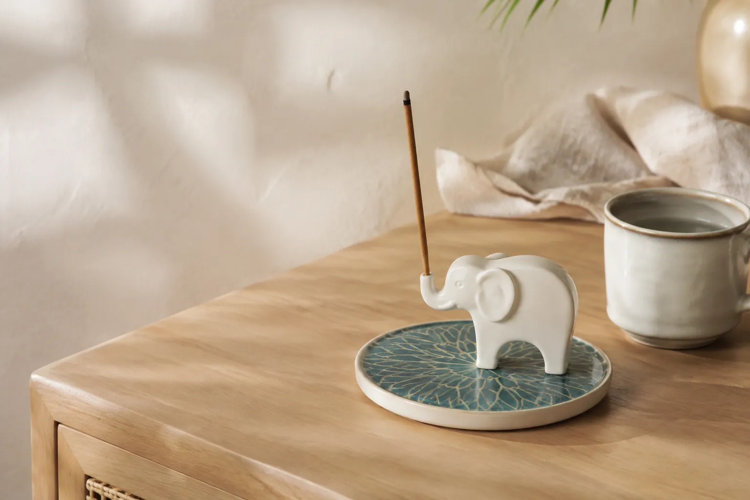 Contemporary elephant incense holder with radial base