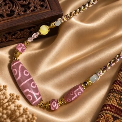 Blush Dzi Necklace with a blush-toned 38 mm focal bead and eye motif