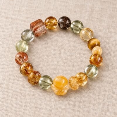 Himalayan Crystal Opportunity Bracelet with green, red, gold, and dark natural crystal beads in a circular arrangement.