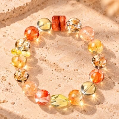 Himalayan Crystal Abundance Bracelet with yellow citrine, gold rutilated quartz, and resin flower beads arranged in a circle.