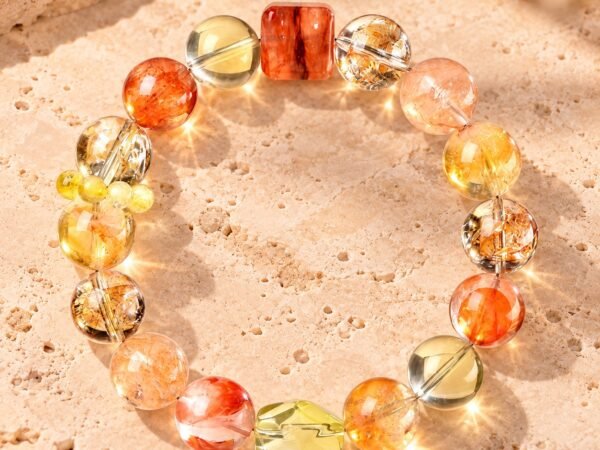 Himalayan Crystal Abundance Bracelet with yellow citrine, gold rutilated quartz, and resin flower beads arranged in a circle.